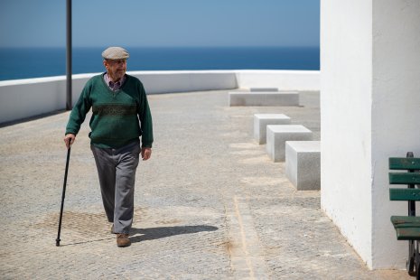 Homme âgé avec une canne sur une place